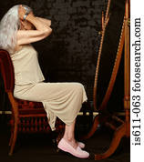 Senior woman looking in mirror 