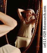 Senior woman looking in the mirror Senior woman looking in the mirror