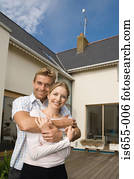 Couple outside their house