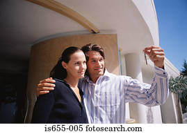 Couple outside their new house