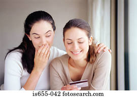 Two women with a credit card
