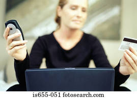 Woman with mobile credit card and laptop