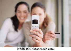 Women with mobile phone and credit card 