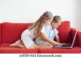 Brother and sister using laptop