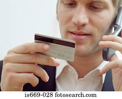 Man on mobile with credit card
