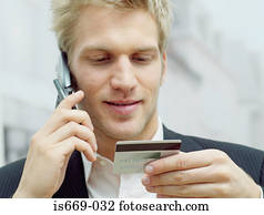 Man on mobile with credit card