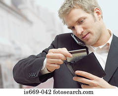 Man on mobile with credit card