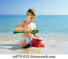 Boy playing with wet sand