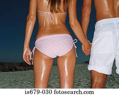 Couple holding hands on the beach