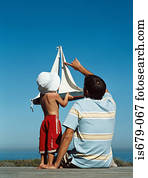 Father and son with toy boat