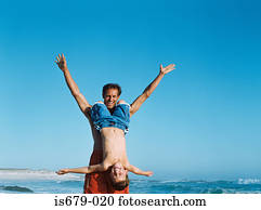 Father holding son upside down