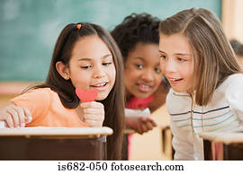 Three girls reading a note