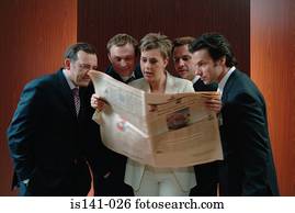 Business people reading paper