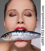 Woman with fish in her mouth