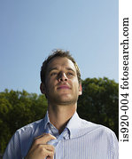 Office worker loosening his necktie