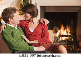 Couple resting by fireplace