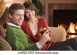 Couple resting by fireplace