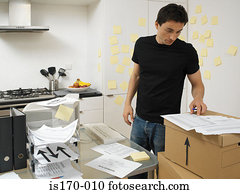 Man with office in the kitchen