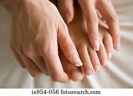 Hands massaging feet