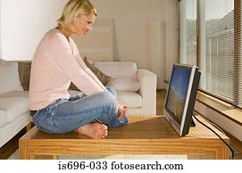 Woman looking at flat screen monitor