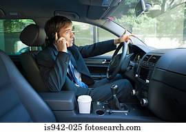 Businessman on cell phone in car