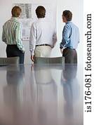 Businessmen looking at architectural plans