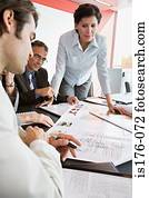 Businesspeople looking at plans