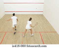 Man and woman playing squash