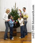 Family decorating christmas tree