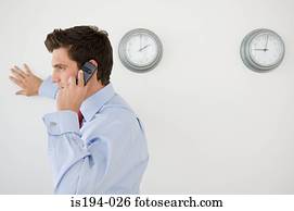 Businessman using cellular telephone