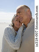 Senior couple hugging on beach