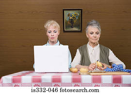 Senior women with laptop and potatoes Senior women with laptop and potatoes