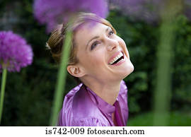 Carefree woman amongst allium flowers