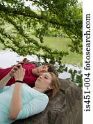 Teenage couple using a cellular telephone