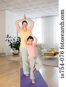 Mother and daughter practising yoga