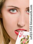 Woman biting a playing card