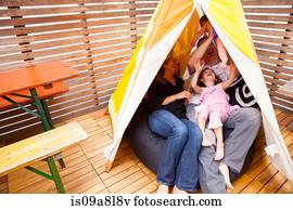 Family playing in tent