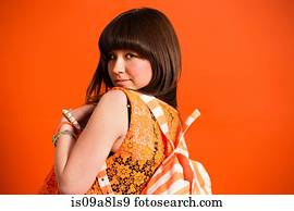 Portrait of young woman wearing orange top