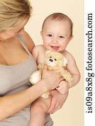 Mother with baby son and teddy bear