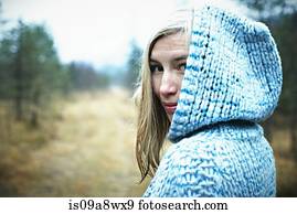 Woman wearing hooded top in forest
