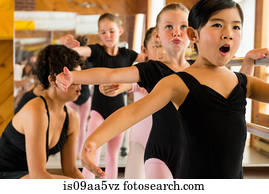Ballerinas practising at the barre in ballet school
