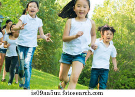 Boys and girls running in park