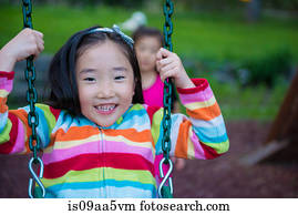 Girl wearing striped top on swing