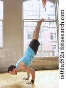 Mid adult man doing handstand