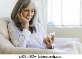 Senior woman looking at smartphone