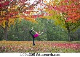 Woman practising yoga in forest