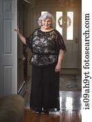 Portrait of well dressed mature woman in hallway