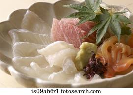 Still life of raw fish dish with leaves