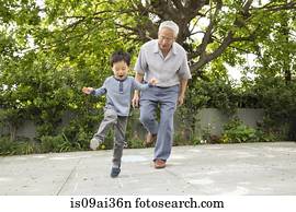Grandfather playing hopscotch with grandson