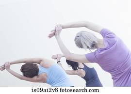 Women practising yoga